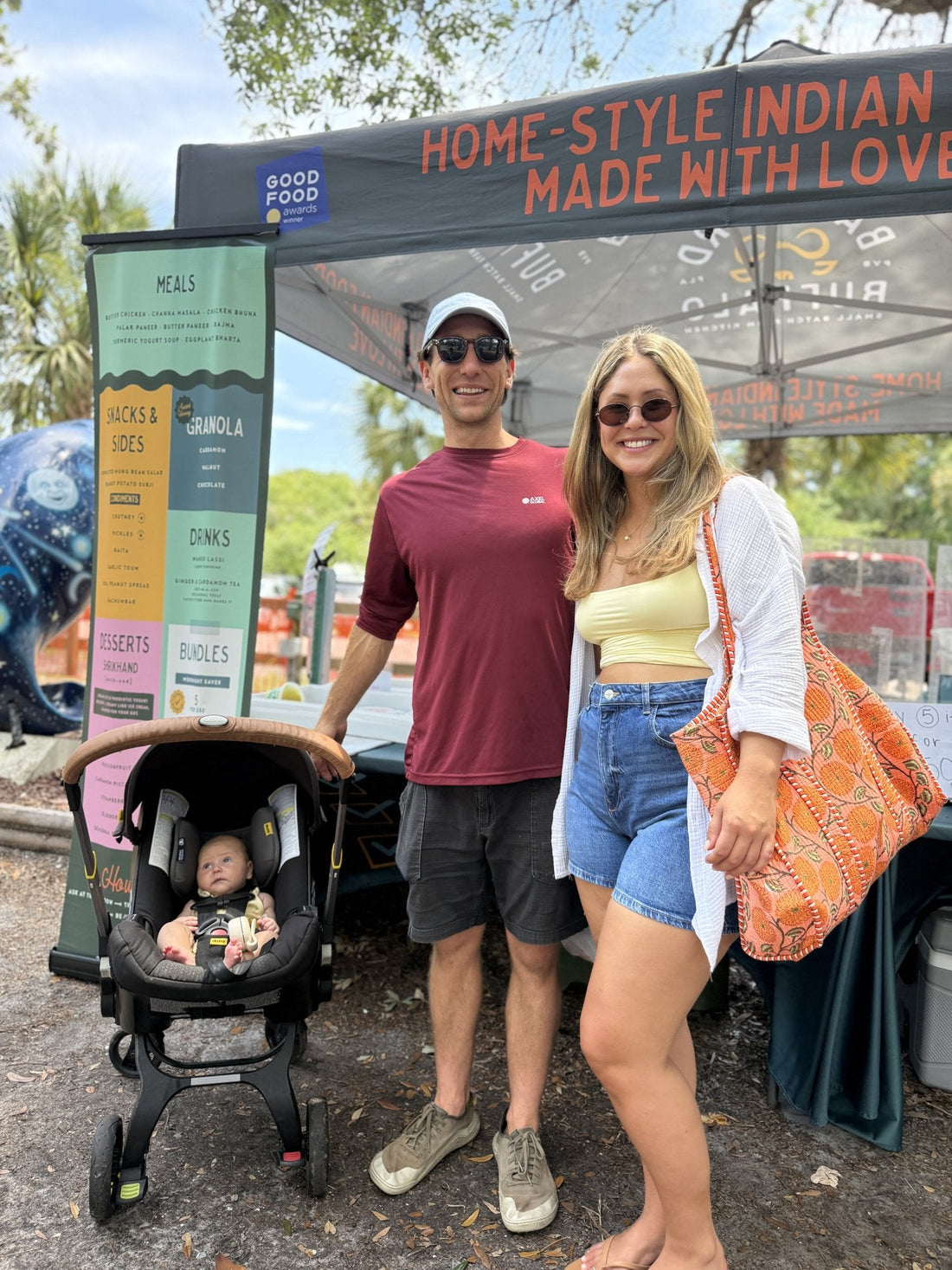 A family with a baby at the Backyard Buffalo market tent