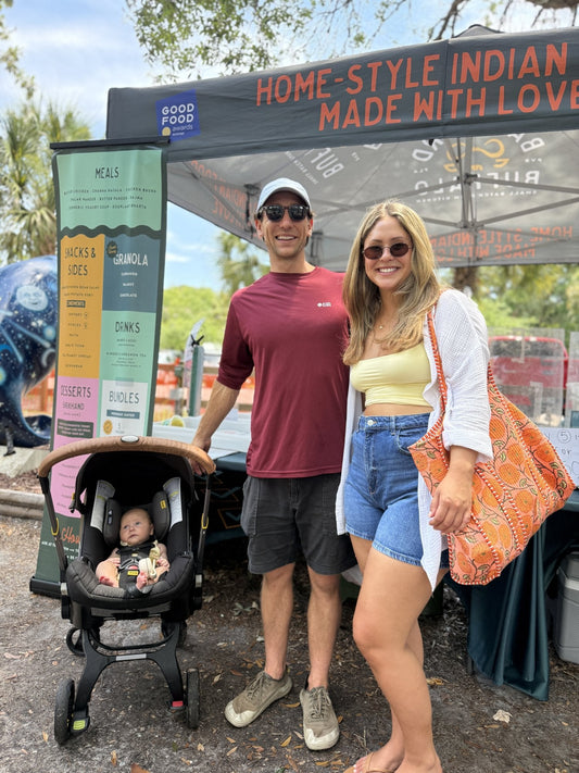 A family with a baby at the Backyard Buffalo market tent